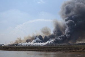 Burning garbage heap of smoke.