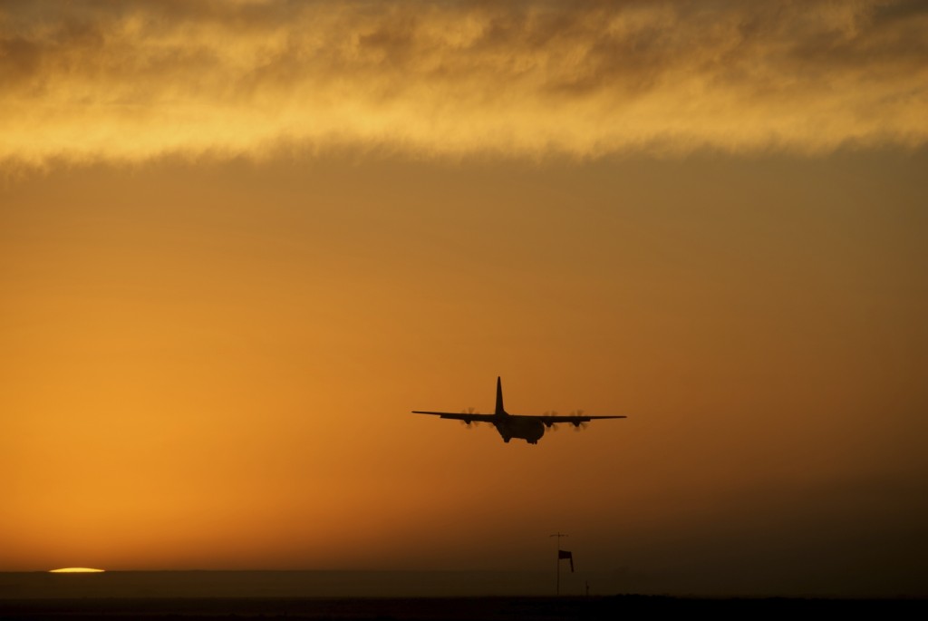 Military plane C130 flying during a sunset in Afghanistan.