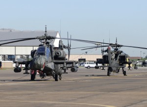 Modern military attack helicopters awaiting deployment at military base.