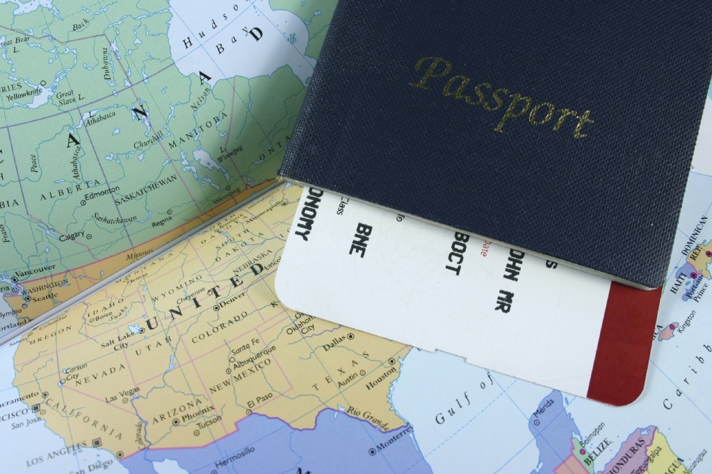Travel Passport and plane ticket on map.