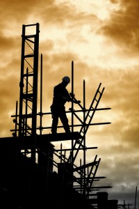 silhouette of construction worker on scaffold