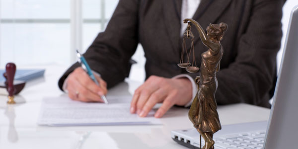 Dba lawyer filling out claim paperwork.